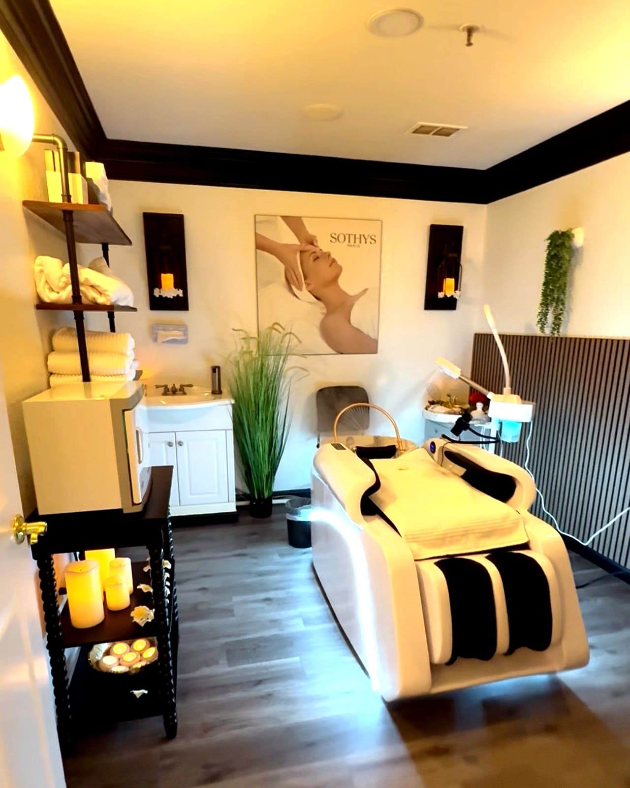 Head spa treatment room with massage chair and Sothys wall art