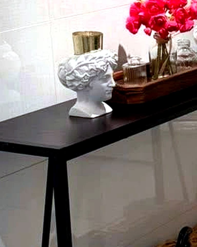 Styled vanity console with fresh flowers and decorative accents