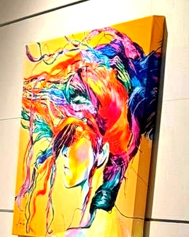Colorful framed art above a styled console table